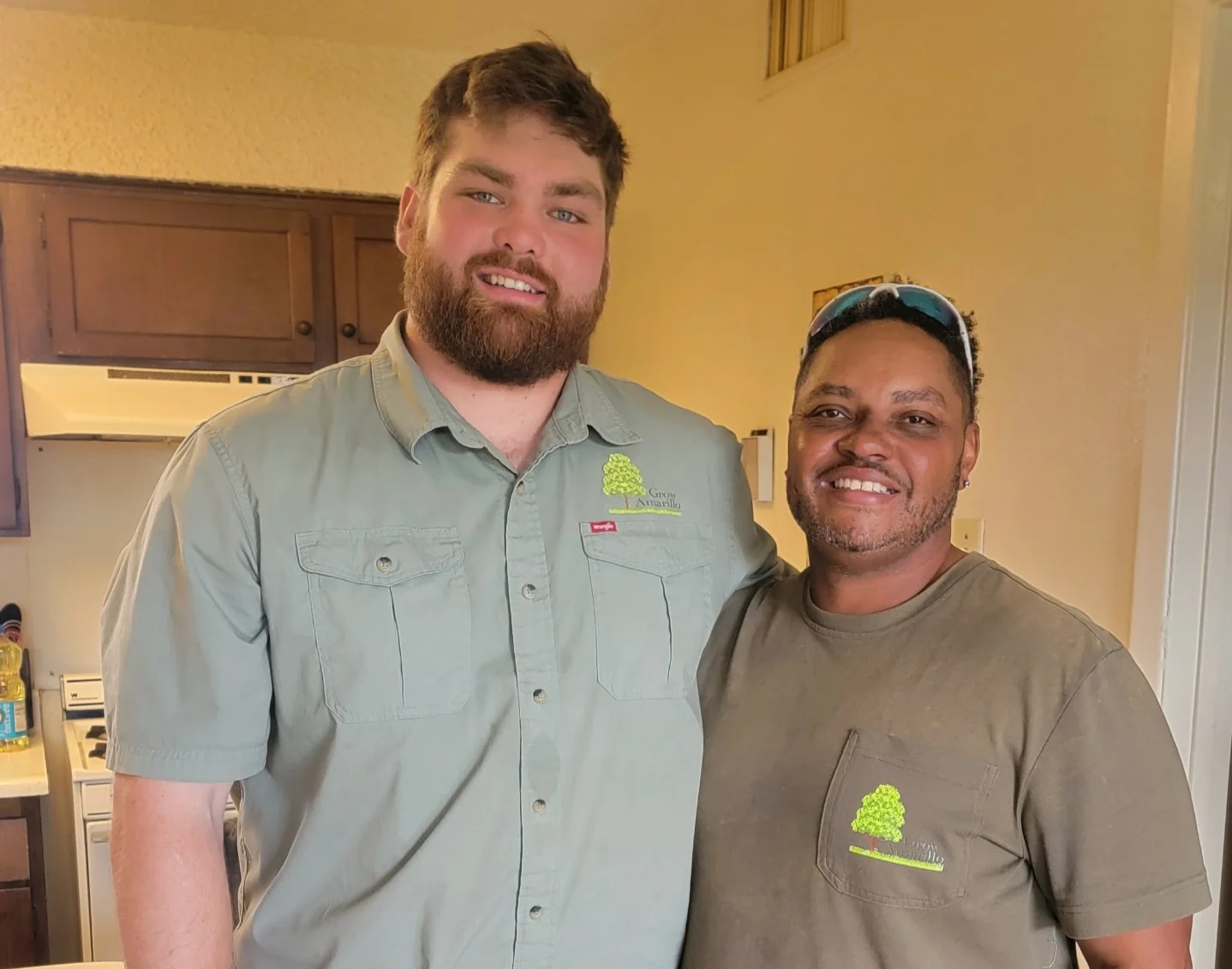 Two men smiling together in a kitchen, from the original organization gallery